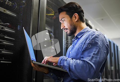 Image of Connectivity, data center and a man with a laptop for maintenance, cyber security and internet check. Coding, email and an Asian programmer typing on a computer for network or server analytics