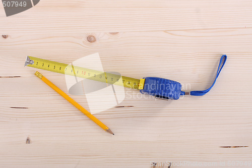 Image of wooden plank and measuring tape 