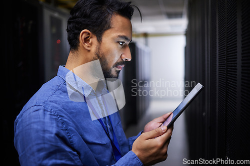 Image of Tablet, man and reading in server room of technician programming at night. Information technology, focus and engineer in data center, cybersecurity network or coding software of system admin research