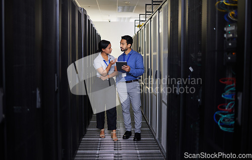 Image of Talking, people and technician in server room with tablet for cybersecurity, update or team problem solving in data or coding. Engineer, teamwork and working with error in information technology code