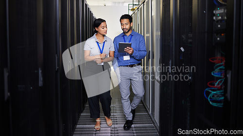 Image of People, server room and teamwork on tablet, cybersecurity, engineering and programming or coding solution. Engineering man and woman or manager walking in data center, digital technology and training