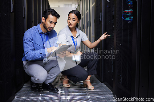 Image of People, talking and technician in server room with tablet for cybersecurity, update or team problem solving in data or coding. Engineer, teamwork and working with error in information technology code