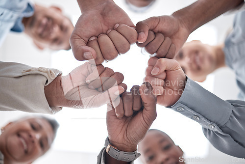 Image of Hands fist bump, group circle and team celebrate community cooperation, mission success or happy corporate achievement. Below view, goals and staff commitment, solidarity and society teamwork support