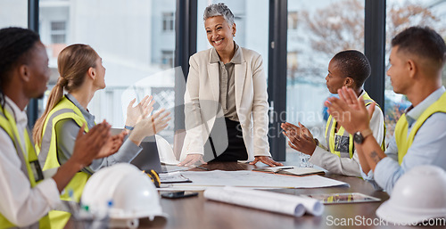 Image of Applause, talking and construction workers in a meeting with a manager for architecture success. Happy, team and architects clapping for a presentation from a boss about infrastructure design