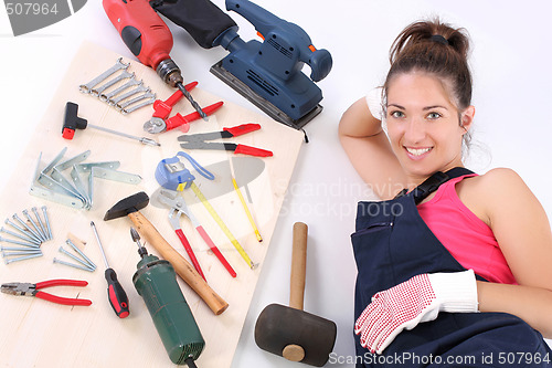 Image of woman carpenter with work tools 