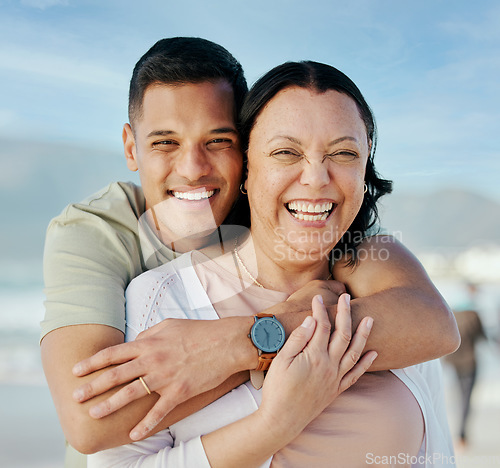 Image of Portrait, hug and man with mother at beach happy, bond and relax in nature together. Love, smile and male face with mom the ocean for freedom, travel and adventure, trip or family holiday in Bahamas