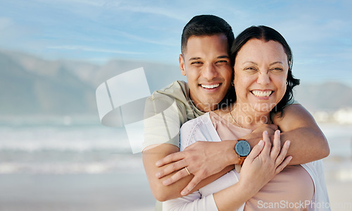 Image of Hug, portrait and couple at the beach with mockup for a date, vacation or bonding. Smile, care and a man and woman with love on a holiday at the sea with space for travel by the ocean for honeymoon