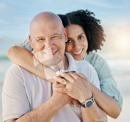 Image of Beach, portrait and woman with her senior dad on family vacation, holiday or adventure. Happy, smile and young female person hugging her elderly father with love and care by the ocean on weekend trip