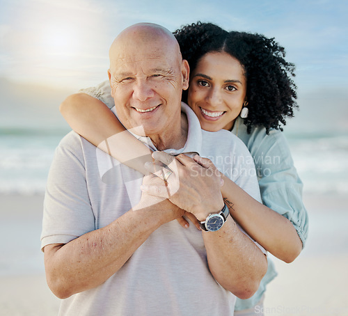 Image of Beach, portrait and woman with her senior father on a family vacation, holiday or adventure. Happy, smile and young female person embracing her elderly dad with love by the ocean on a weekend trip