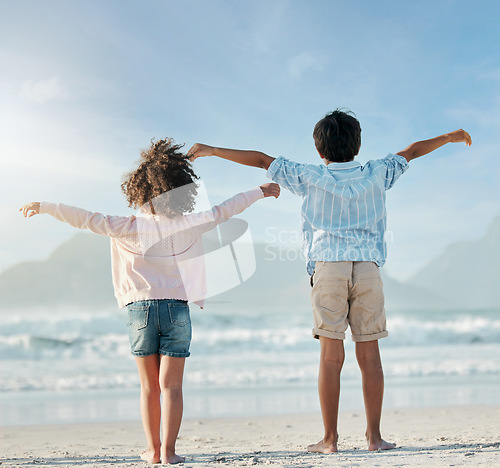 Image of Kids, playing and airplane on beach, vacation or freedom on holiday in summer in Brazil with ocean, blue sky and happiness. Girl, boy and children play game as plane to fly for fun, bonding together