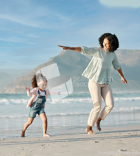 Image of Mom, child and playing on beach, running together in summer waves on tropical island holiday in Hawaii. Fun, mother and daughter on ocean vacation with airplane games to relax in water with blue sky.