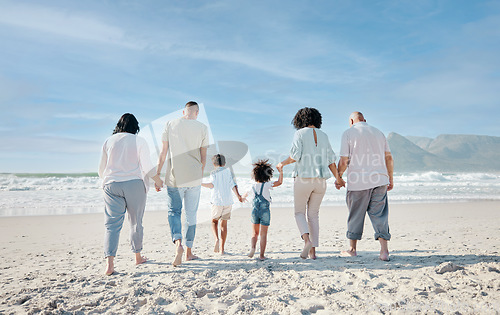 Image of Family, holding hands and relax outdoor on a beach with love, care and happiness for summer vacation. Behind, space in sky or travel with men, women and children together at sea for holiday adventure