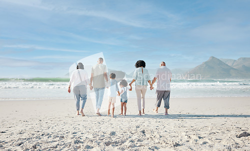 Image of Family, holding hands and walking outdoor on a beach with love, care and happiness on summer vacation. Behind, space in sky or travel with men, women and children together for holiday adventure