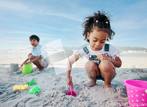 Image of Boy, girl and shovel with bucket, beach and digging sand with playing, outdoor and vacation in summer. Kids, siblings and plastic toys for sandcastle, construction game and happy for holiday by ocean