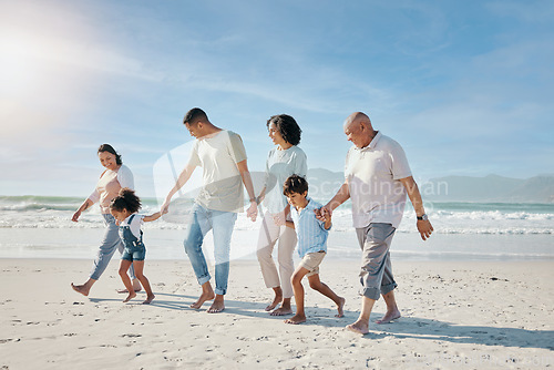 Image of Family, holding hands and walking outdoor on a beach with love, care and happiness for summer vacation. Parents, grandparents or travel with men, women and children together for holiday adventure