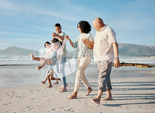 Image of Walking, holding hands and family with children on a beach with love, care and happiness on travel vacation. Parents, grandparents or men and women with kids outdoor for holiday, journey or adventure