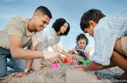 Image of Parents, children and sandcastle at beach, bucket and digging for bonding, outdoor and vacation in summer. Mother, father and kids with plastic toys, sand and games on holiday, teamwork and ocean