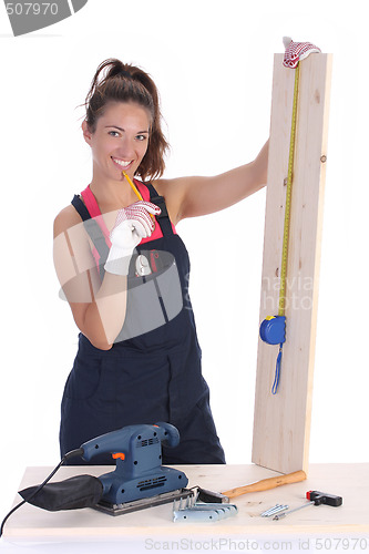 Image of woman carpenter with wooden plank 