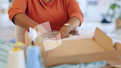 Image of Black woman, hands and box in logistics for delivery, ecommerce or shipping cargo at office desk. Hand of African American female in small business packing product for shipment or courier service