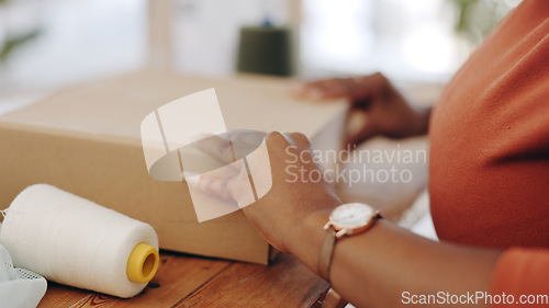 Image of Black woman, hands and box in logistics for delivery, ecommerce or shipping cargo at office desk. Hand of African American female in small business packing product for shipment or courier service