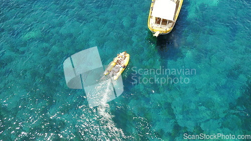 Image of People on boat from above, sailing in Greece and summer sun on ocean holiday, relax in freedom and nature. Yacht vacation, aerial view of travel and tropical cruise on sea adventure to Greek island.