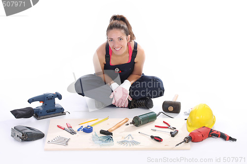 Image of woman carpenter with work tools