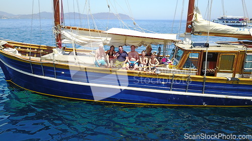 Image of Group of people on boat, sailing in Greece and summer sun on ocean holiday, relax in freedom and nature. Yacht vacation, family travel and tropical cruise on sea adventure to Greek island on blue sky