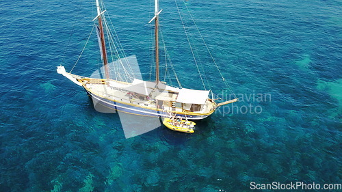 Image of People on yacht, aerial sailing in Greece and summer sun on ocean holiday, relax in freedom and nature. Boat vacation, family travel and tropical cruise on sea adventure to Greek island on blue water