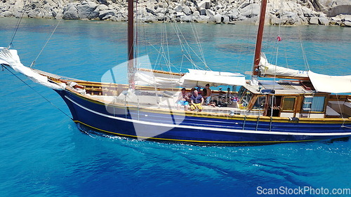 Image of People on wooden boat, sailing in Greece and summer sun on ocean holiday, relax in freedom and nature. Yacht vacation, family travel and tropical cruise on sea adventure to Greek island on blue water