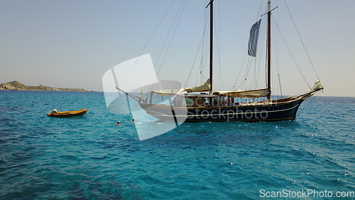 Image of Yacht, sailing in Greece and summer on ocean holiday, relax in freedom and people swimming in blue water. Boat vacation, travel in sun and tropical cruise on sea adventure with island beach fun.