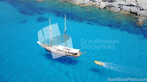 Image of Yacht, sailing in blue water and summer sun on ocean holiday, relax in freedom and nature. Boat vacation, aerial of travel and tropical cruise on adventure to Greek island with sunshine, fun and sea.