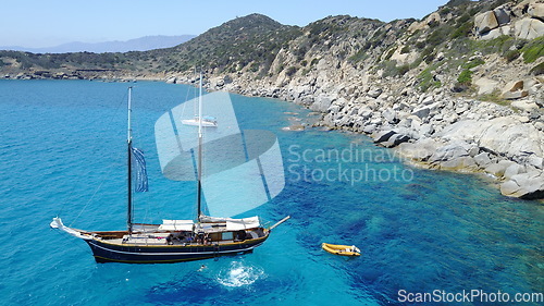 Image of Boat, sailing in Greece and sun on ocean holiday, relax in freedom and nature with clean blue water. Yacht vacation, travel in summer and tropical cruise on fun sea adventure with island beach coast.