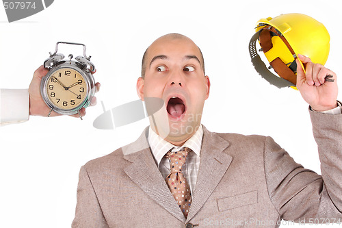 Image of businessman looking at clock alarm