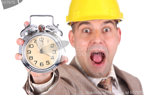 Image of businessman looking at clock alarm