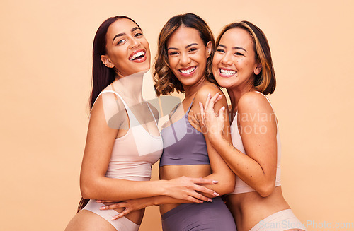 Image of Diversity, natural beauty and portrait of happy women with smile, self love and solidarity in studio. Happy face, group of people on beige background with underwear, global skincare and cosmetics.