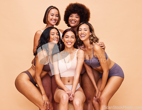 Image of Diversity, beauty and portrait of happy women with body positivity, self love and solidarity in studio together. Smile, group of people on beige background in underwear, skincare and makeup cosmetics