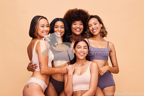 Image of Body portrait, underwear and group of women in studio isolated on a brown background. Smile, lingerie and friends with empowerment, inclusion and positivity, natural beauty and wellness for diversity