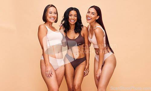 Image of Happy portrait, underwear and group of women in studio isolated on a brown background mockup space. Smile, lingerie and friends in natural beauty, self love and body positivity, health and wellness