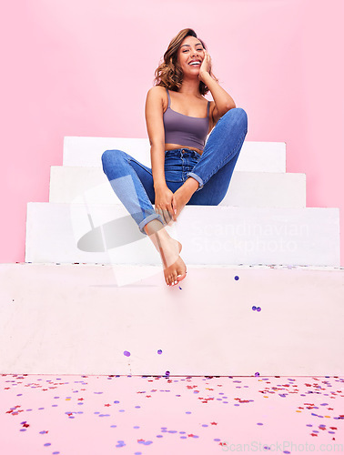 Image of Happy woman, confetti and steps portrait with smile, style and fashion with celebration sparkle. Studio, pink background and female model with party and birthday decoration with gen z confidence