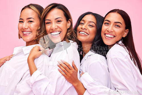 Image of Women, friends smile and portrait in studio with natural beauty, diversity and white shirt with laugh. Pink background, bonding and young female group together with inclusion, happy hug and wellness