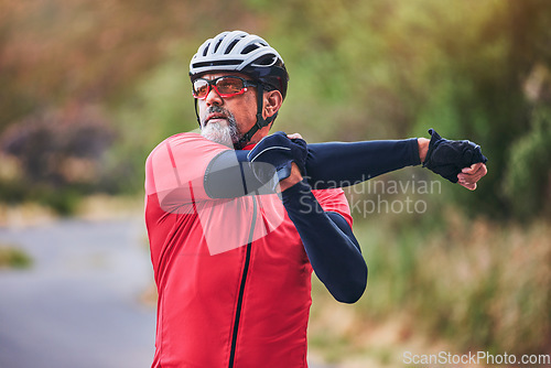 Image of Man, cyclist and stretching arms on mountain in sports fitness, workout or outdoor exercise in nature. Active male person or athlete in body warm up, cycling or ready for cardio marathon or training