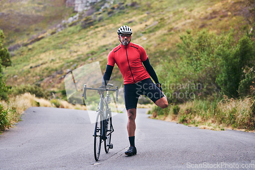 Image of Road, bike and man stretching, fitness and exercise with training, warm up and outdoor sports with wellness. Person, cyclist or athlete stretch, workout and nature with health, performance and cardio