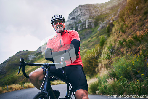 Image of Portrait, cycling and arms crossed with man in nature for sports, training and challenge. Exercise, workout and health with mature person on bike in mountains for energy, freedom and performance