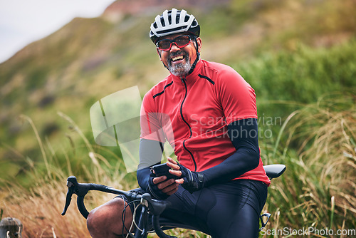 Image of Fitness, cycling and phone with portrait of man on bike in nature for sports, training and social media. Contact, communication and health with mature person in mountains for energy, freedom and app