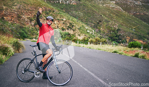 Image of Selfie, mountain and man cycling for exercise, training and workout goals in nature for social media. Sports, travel blog and male cyclist take picture for wellness, cardio and fitness on adventure