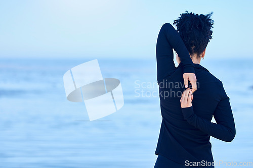 Image of Back, beach and woman with exercise, stretching and wellness with sports, workout and cardio with performance. Person, outdoor or athlete stretch arms, training or mockup space with health or fitness