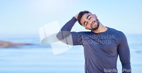 Image of Beach, exercise and man stretching neck for outdoor freedom, sports workout or advertising space. Blue sky mockup, ocean water and Indian person start relax training warm up, challenge or muscle care