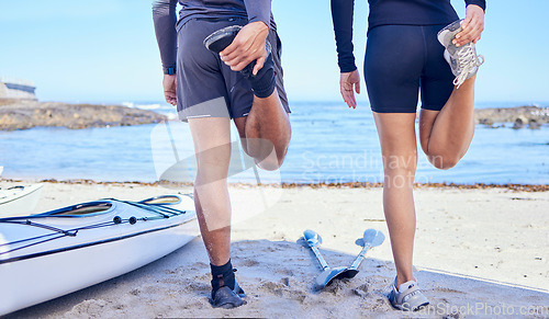Image of Beach legs, rowing and stretching people, partner or couple of friends for fitness, teamwork and start workout routine. Nature, sports challenge or back of kayaking team training, exercise or warm up