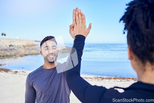 Image of Fitness, couple and high five on the beach for exercise, outdoor workout or training for water sports, teamwork and healthy cardio. Happy, man and woman athlete with motivation or support in winning