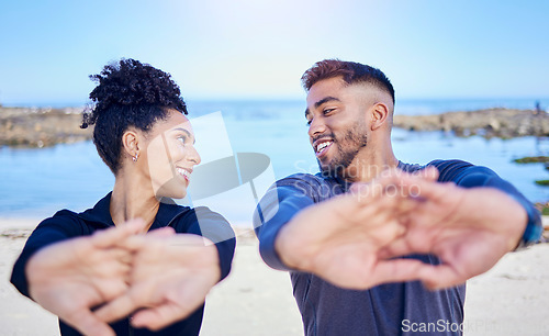 Image of Beach workout, stretching hands and happy couple of friends smile for team exercise, sports or athlete fitness. Summer wellness, eye contact and nature people training, active and start warm up